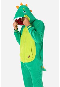 Tutina verde a tema dinosauro realizzata in morbido pile, con cappuccio con denti, spuntoni arancioni e una grande tasca sul davanti.