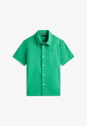 Camicia verde a maniche corte con bottoni, colletto e piccolo logo a bandiera Tommy Hilfiger sul petto sinistro.