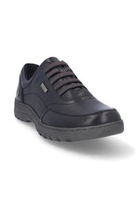 Zapatos de cuero negro con cordones, superficie texturizada, cuello acolchado y suela de goma con un sutil detalle de logo.