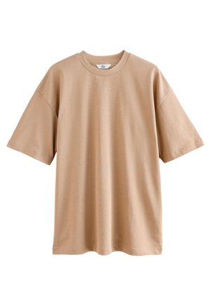 Beżowy oversize bawełniany t-shirt z krótkim rękawem, okrągłym dekoltem i opuszczonymi ramionami, pokazany rozłożony na białym tle.