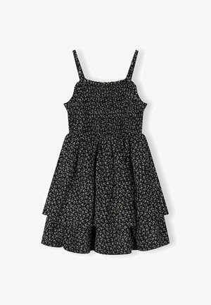 Musta hihaton mekko, jossa on ohuet olkaimet, smokkauksella koristeltu yläosa, levenevä kerroksellinen helma ja pieni valkoinen kukkakuvio.