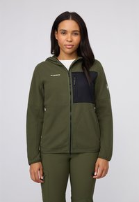 Green fleece jacket with a black chest panel, zip closure, and hood; features logo accent and zippered pocket on the left side.