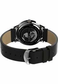 Timex watch with a black silicone strap and stainless steel case, featuring a globe design on the back. Water-resistant up to 50 meters.