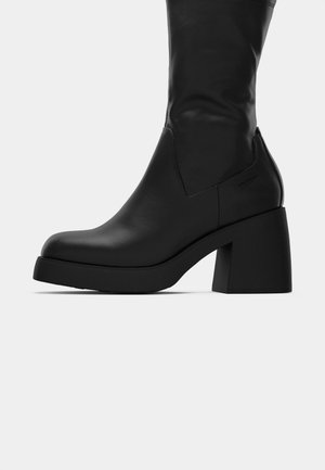 Black mid-calf leather boot with chunky block heel and rounded toe, showing side profile on white background.