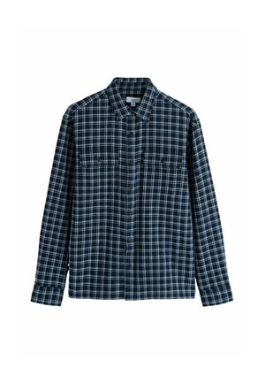 Chemise en flanelle avec un motif à carreaux bleu marine et blanc, fermeture à boutons, col évasé et deux poches poitrine à rabats.
