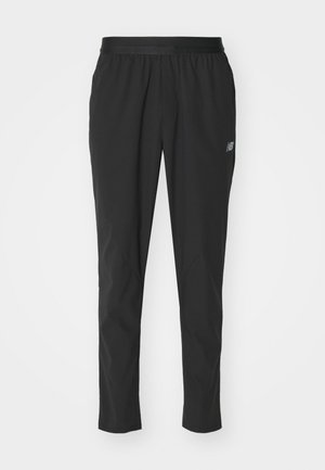 Schwarze Sporthosen aus leichtem Material mit elastischem Bund, schmalem Schnitt und dezentem Logodetail an der Seite.