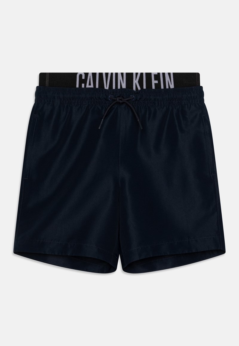 Mornarska kupaćica napravljena od glatkog materijala, s crnim elastičnim pojasom na struku sa logotipom "CALVIN KLEIN" i prednjim vezanjem.