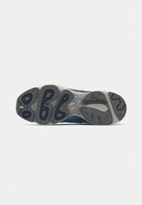 Blue athletic shoe sole with a textured gray rubber outsole, featuring black and gray traction elements and the "new balance" logo.