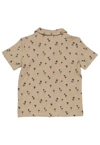 Lyhythihainen paita beigeistä kankaista, jossa on palmupuukuvio tummansinisellä. Varustettu kauluksella ja rento leikkaus. Pehmeä tekstuuri kokoajan.