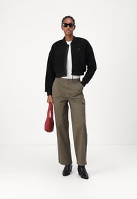 Tommy Jeans Flisinė striukė - black