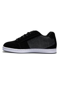 Black sneaker with a suede upper and a textured black fabric panel. Features a white rubber sole and black laces. Low-profile design.