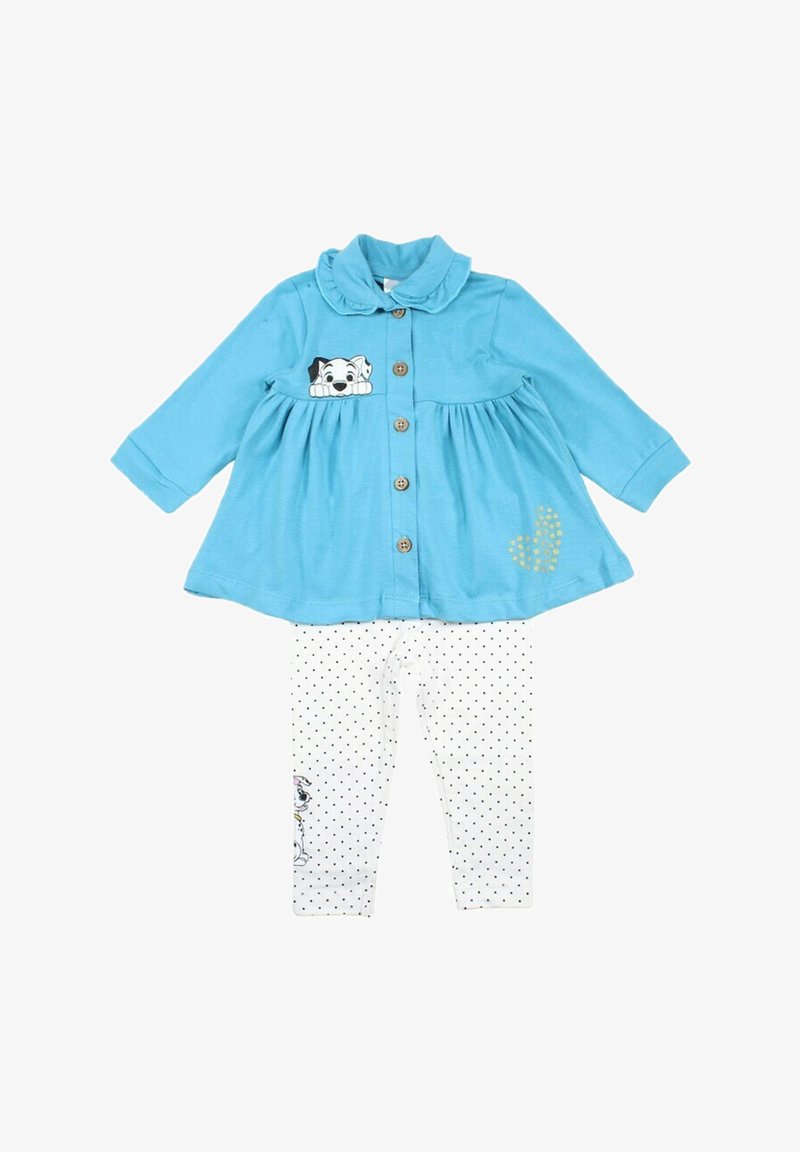 Robe bleu à boutons avec un col et un motif de chien ; associée à des leggings blancs avec des pois noirs et un imprimé de chien.