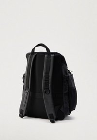 Zaino nero con tessuto strutturato e schienale imbottito. Dotato di spallacci regolabili, tasca laterale e manico superiore per facilità di trasporto.