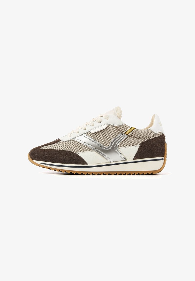 Brown and white sneaker with mesh and suede materials, silver accents, a textured sole, and a retro design featuring a rounded toe.