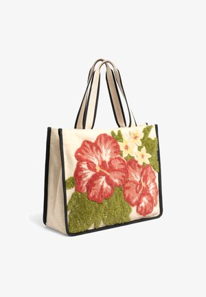 Sac cabas beige avec bordure noire, orné d’une broderie florale texturée rouge et jaune et de poignées rayées doubles.