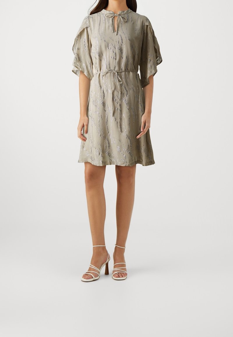 Light green short dress with a tied neckline, flutter sleeves, and a cinched waist. It features a textured pattern and falls above the knees.