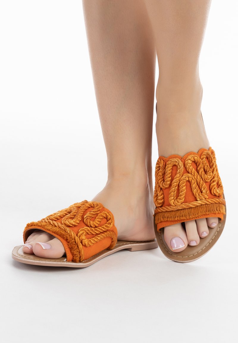 Narancssárga textil csúszó szandál, texturált kötél részletezéssel. Lapos talp, lekerekített nyitott orra és bonyolult varrás az élein.