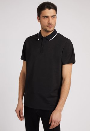 Black polo shirt made of cotton, featuring short sleeves, a three-button placket, and a white trim on the collar.