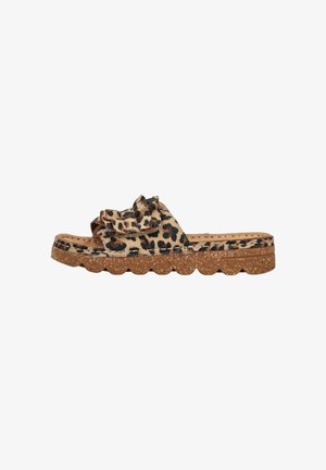Slide sandal with leopard print fabric upper, ruffle detail, and thick cork sole with scalloped edge.