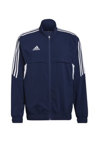 Donkerblauwe sportjack met witte horizontale strepen, volledige rits, hoge kraag en elastische manchetten; beschikt over het Adidas-logo op de borst.