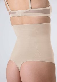 Pantaloni shaping beige a vita alta con texture liscia e vita elastica. Design senza cuciture ai bordi per una silhouette snella.