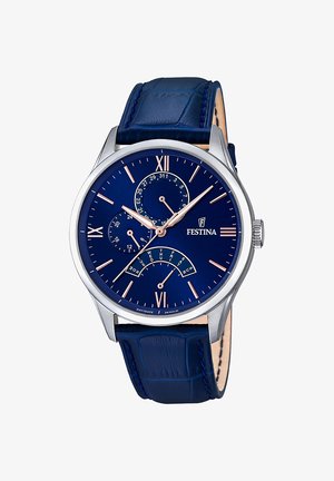 Reloj de hombre con un dial redondo azul, manecillas en tono plateado y acentos en oro rosa. Presenta una correa de cuero con patrón de cocodrilo azul.