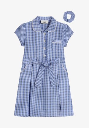 Mėlyna ir balta languota suknelė su trumpomis rankovėmis, krakmoliniu apykakle, priekiniais mygtukais, šoninėmis kišenėmis ir surišama liemene; komplekte yra suderintas scrunchie.