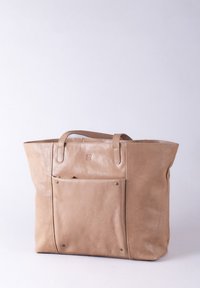 Tan leather tote bag with dual handles, a front pocket secured with snaps, and a textured finish. Rectangular shape with minimal decoration.