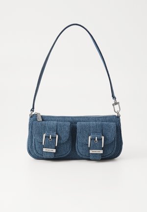 Denim handbag in dark blue with silver hardware. Features two front pockets with flap closures and a single shoulder strap. Zip closure on top.