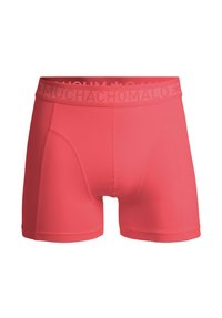 Červené boxerky so priliehavým strihom, ponúkajúce hladkú textúru a široký pás s embosovaným názvom značky "MUCHACHOMALO."