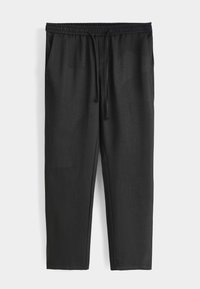 Pantalon de jogging noir en tissu lisse. Il est doté d'une taille élastique avec cordon de serrage et de poches latérales. Coupe fuselée au niveau des jambes.