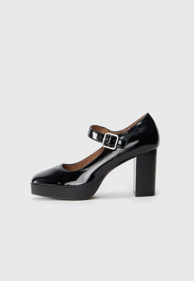 Black patent leather high-heeled Mary Jane shoe with a square buckle strap and a block heel, featuring a rounded toe and a platform sole.