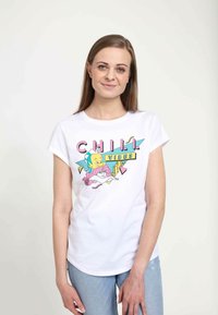 Biała koszulka z kolorową grafiką, na której jest napis "CHILL VIBES", z postaciami z kreskówek i kształtami geometrycznymi. Krótkie rękawy, dopasowany krój.