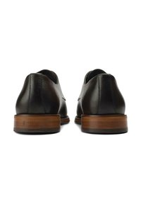 Black leather shoes with a smooth finish, a low heel featuring a wood accent, and clean stitching along the seams.