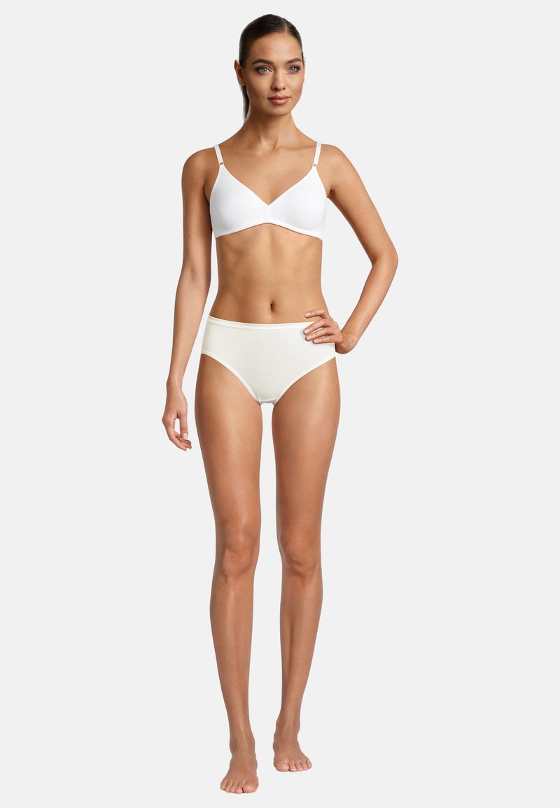 Soutien-gorge bianco con spalline sottili e design senza cuciture abbinato a mutande crema a vita alta. Texture liscia, stile minimalista, senza modelli visibili.