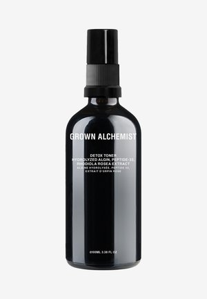 Black glass bottle with a matte finish, featuring a black spray nozzle. Label text in white identifies product as Detox Toner, 100ml.
