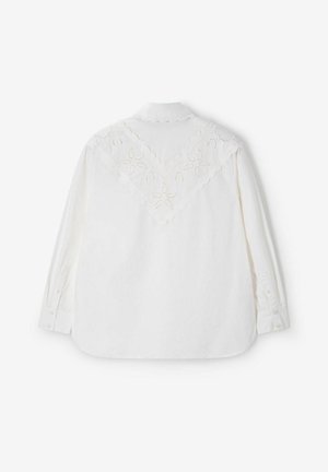 Wit shirt met lange mouwen, voorzien van een geschulpte kanten inzet en bloemenborduursel op de bovenrug en kraag, met knoopmanchetten.