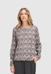 Blusa a maniche lunghe in tessuto stampato con forme di diamante nei toni del beige, grigio e blu. Vestibilità comoda con scollatura tonda e polsini elasticizzati.