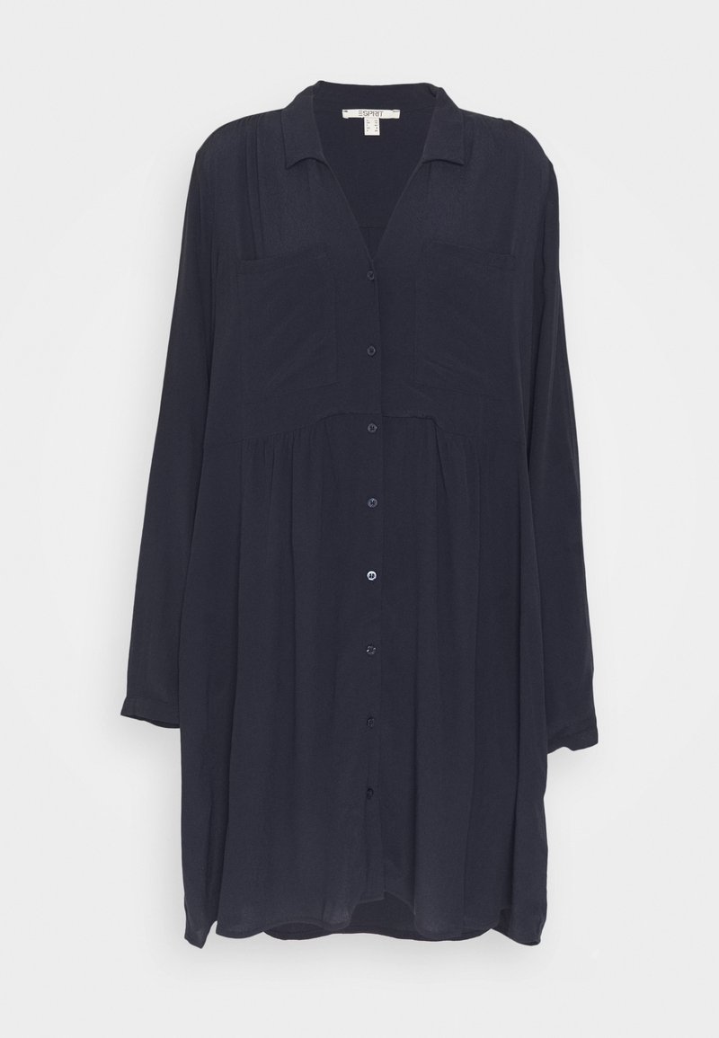 Robe-chemise à manches longues bleu marine foncé avec col et deux poches poitrine, coupe ample et tissu léger.