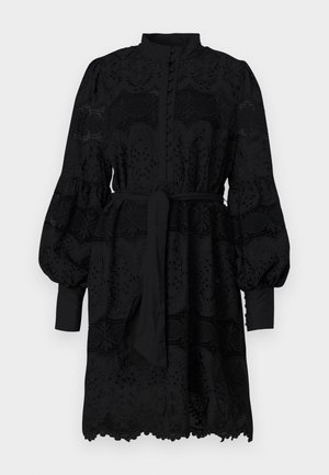 Schwarzes Kleid mit hohem Kragen, Knopfleiste und langen Puffärmeln. Verfügt über spitzenartige Stickerei und einen bindeband an der Taille.