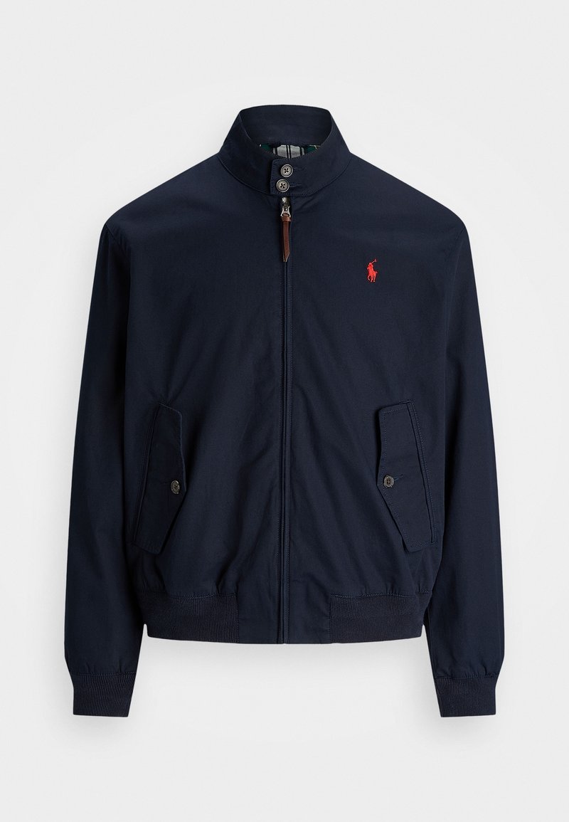 Navy blue jacket with a high collar, front zip closure, and two side pockets. Includes a red logo on the left side and ribbed cuffs.