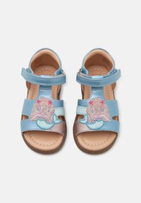 Blå sandaler med havfrue broderi, skinnende stropper, åben tå design og en brun tekstureret sål.