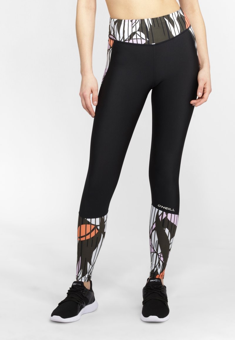 Leggings neri a vita alta con una stampa astratta colorata in vita e sulle gambe inferiori. Realizzati in tessuto elastico e morbido.