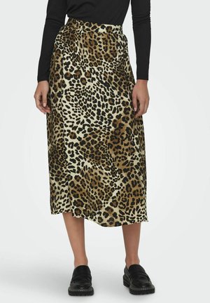 Jupe midi en imprimé léopard en tissu doux, dotée d'une taille haute avec des plis. Accentuée par des chaussures noires à enfiler pour le contraste.