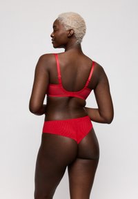 Rode beha- en ondergoedset, gemaakt van gladde stof, met verstelbare bandjes en een naadloos ontwerp. De artikelen worden van achteren getoond.