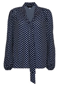 Blouse marine avec un col en V, des manches bouffantes longues et un lien à la taille, ornée d'un motif de cœurs blancs sur le tissu.