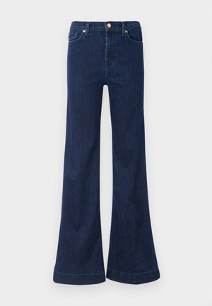 Jeans flare de um azul escuro, feitos de denim, com uma cintura alta, leve desgaste na zona das coxas e detalhes em dourado nos bolsos da frente e no fecho.
