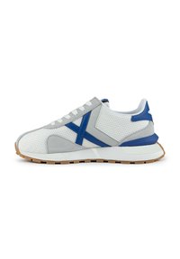 White sneakers featuring a mesh upper with gray and blue suede accents, a blue heel tab, and a rubber sole with a textured pattern.