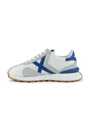 White sneakers featuring a mesh upper with gray and blue suede accents, a blue heel tab, and a rubber sole with a textured pattern.