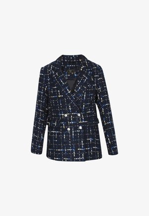 Tamsiai mėlynas tviterinis švarkas su tekstūriniais raštais, dvigubu užsegimu priekyje ir sidabrinėmis sagomis. Struktūruoti apykakliai ir prigludęs liemuo.